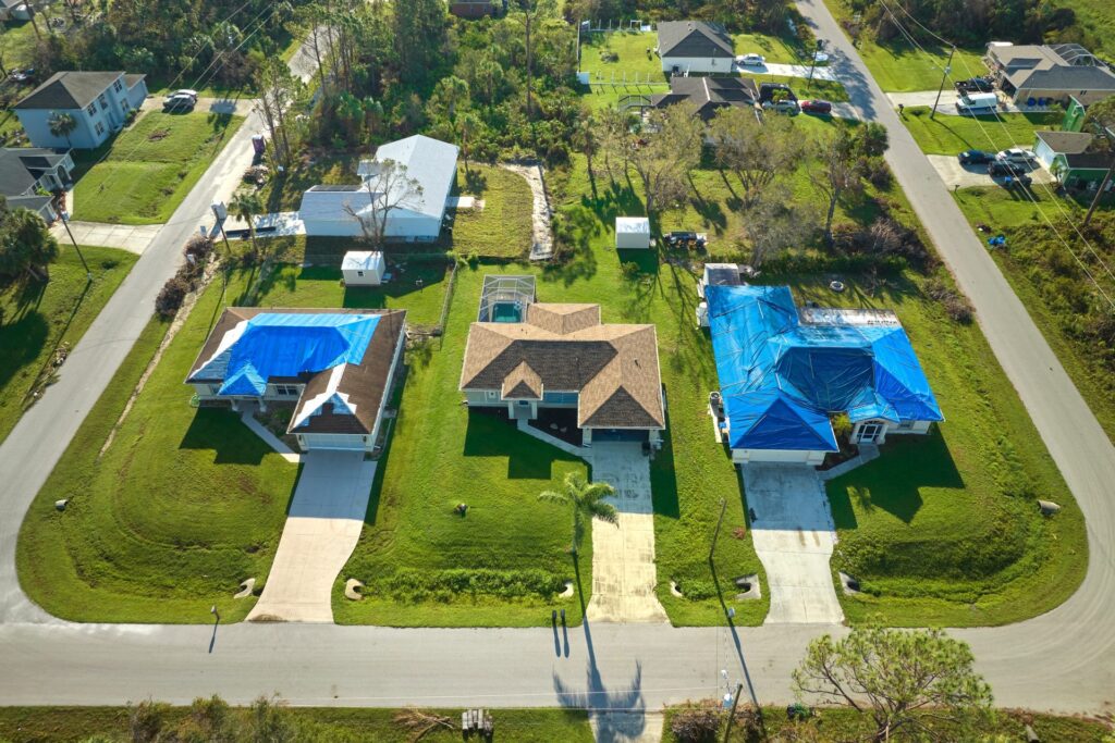 Aerial,View,Of,Damaged,In,Hurricane,Ian,House,Roof,Covered