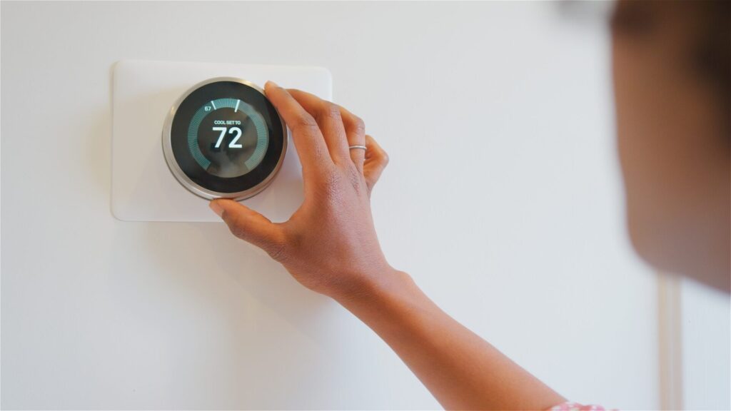 Close,Up,Of,Woman,Setting,Digital,Smart,Heating,Thermostat,At