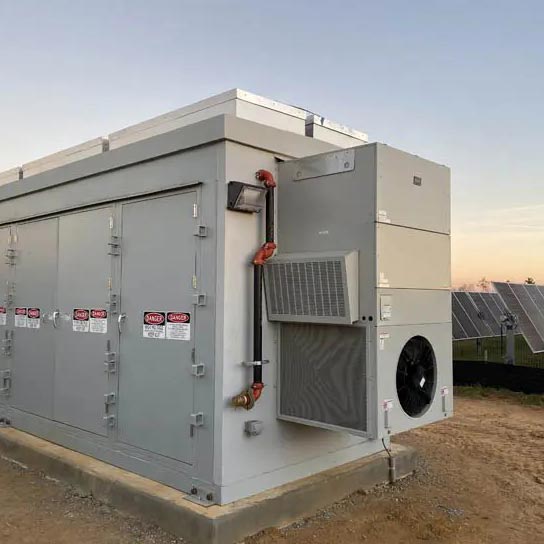 A large barred wall-mount air conditioning unit mounted on an electrical cabinet