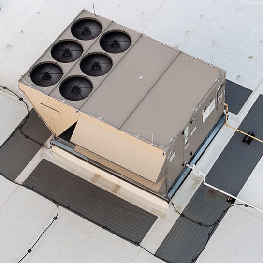 comm-maint-roof-unit-544x544-v1 A commercial air conditioning and heating unit on the roof of a business