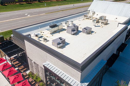 A restaurant with heating and air conditioning units visible on the roof